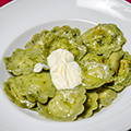 Home-made green ravioli with three cheeses